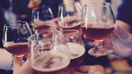 Photo of people toasting with a glass of beer