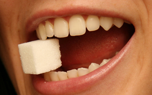 Freedom from Sugar: sugar cube in teeth