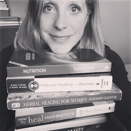 Ecohuman Health's co-founder, Bree,  in her happy place, with a pile of books. 